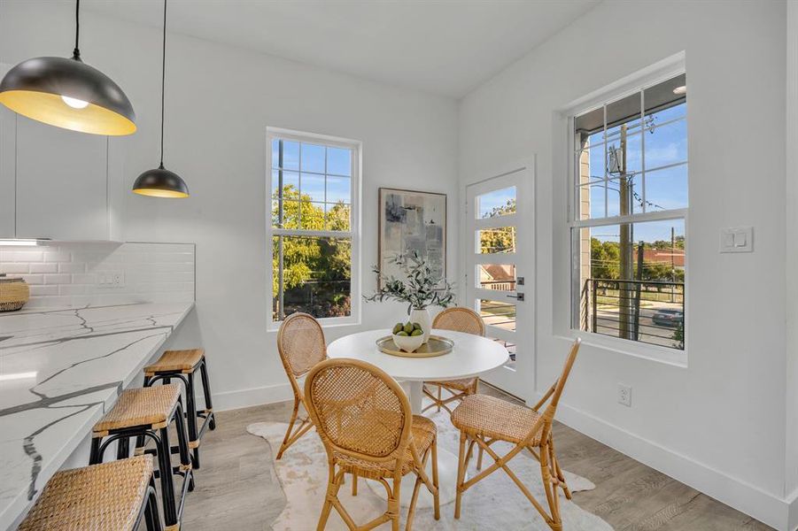 Dining area with light hardwood / wood-style flooring