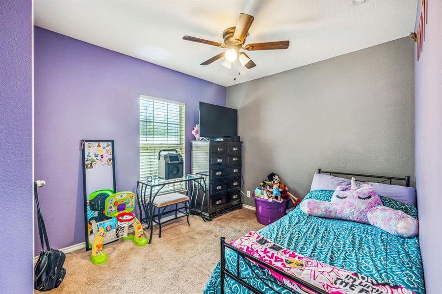 Bedroom featuring ceiling fan and light colored carpet