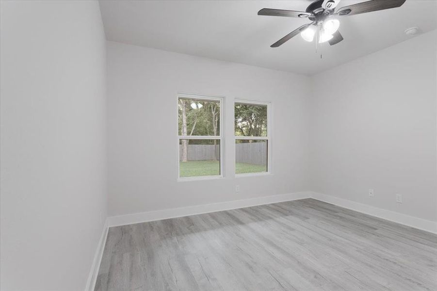 Empty room featuring ceiling fan and light hardwood / wood-style floors