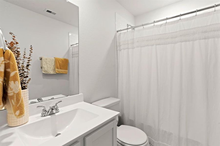 Conveniently located upstairs, this well-appointed secondary bathroom offers privacy and comfort.