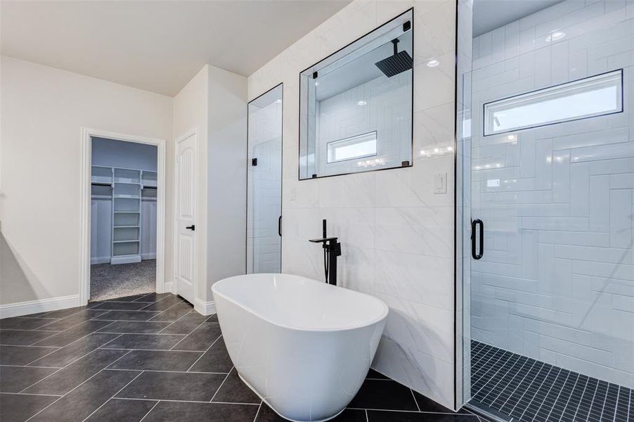 Bathroom featuring GORGEOUS shower and bath, tile patterned floors, and tile walls