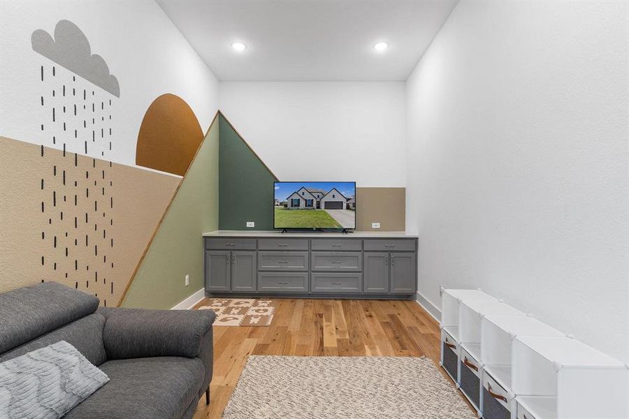 Theatre Room off Living Area / light hardwood / wood-style floors