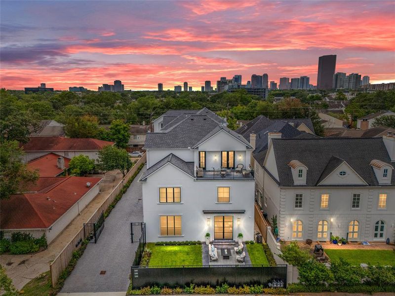 The welcoming front elevation of 1207 Nantucket highlights the prime, front location in the gated enclave, the large yard, and the metal glass doors and windows.