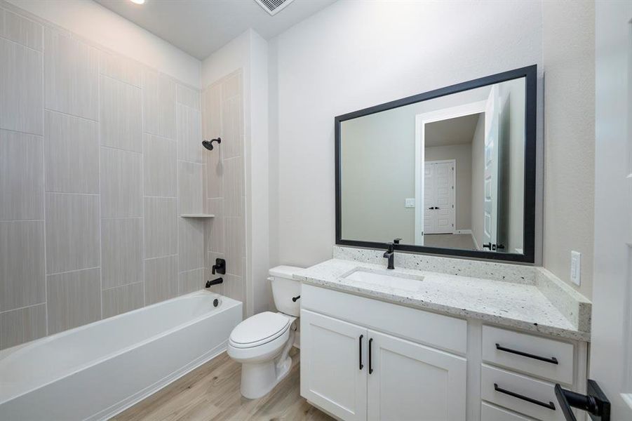 Each bathroom has expansive vanities offering an abundance of storage below.