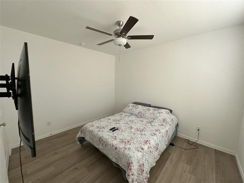 Bedroom featuring hardwood / wood-style floors and ceiling fan