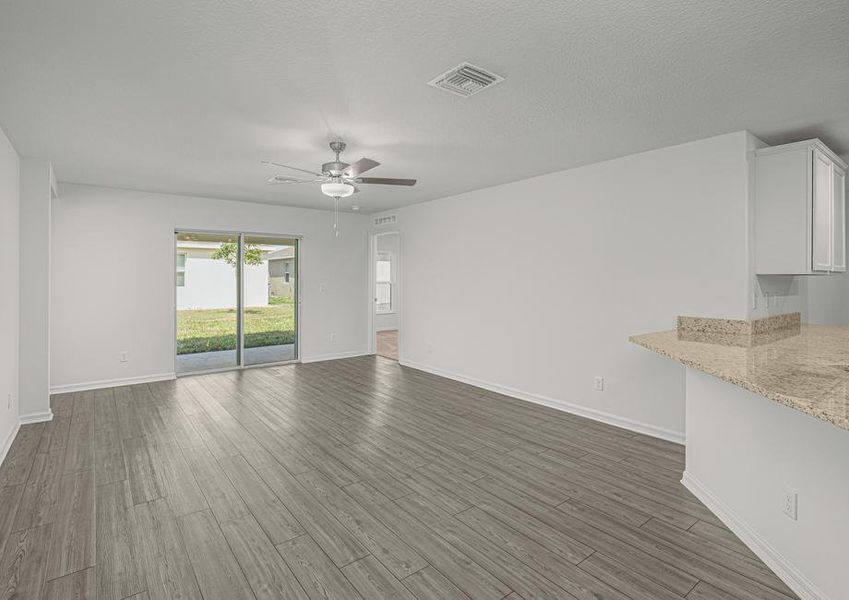 The family room is spacious with a sliding door leading to the back patio