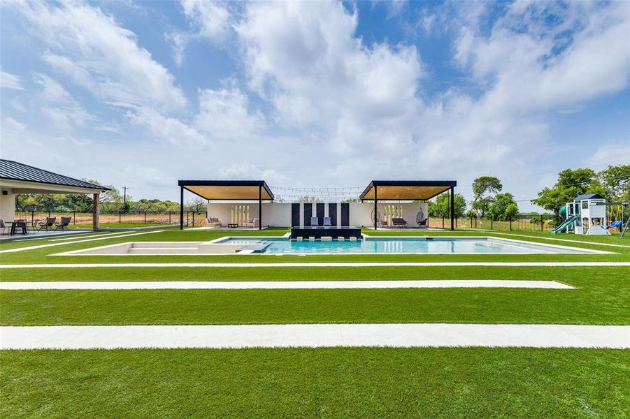 View of home's community featuring a yard, a playground, and a swimming pool