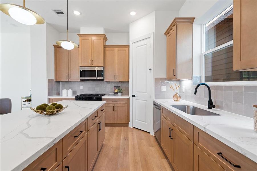 Beautiful open kitchen with stunning Zellige mosaic backsplash.