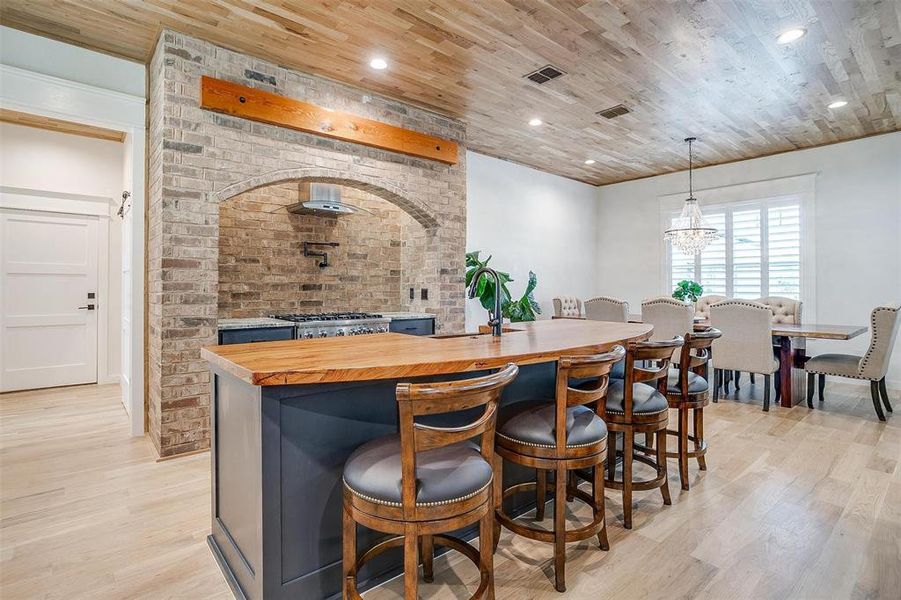 A close-up of the 300-year-old pecan island, topped with the hand-hammered copper sink imported from Mexico, adding a touch of rustic elegance.