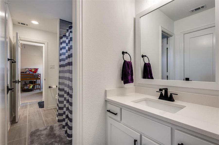 Bathroom featuring vanity and tile patterned flooring