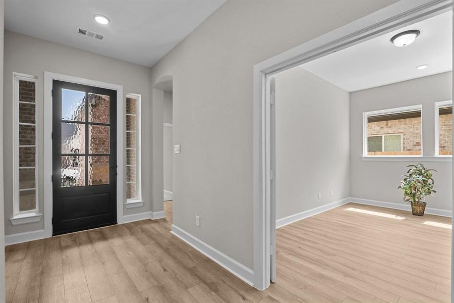 8 ft front door, vinyl plank floors, 10 ft ceilings all compliment this beautiful home!