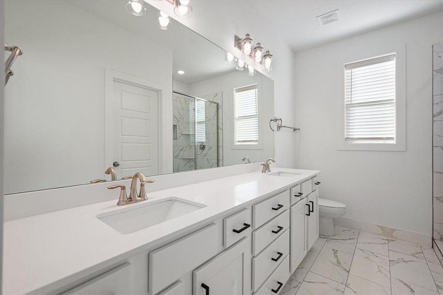 Primary bathroom with tile floors and oversized vanity