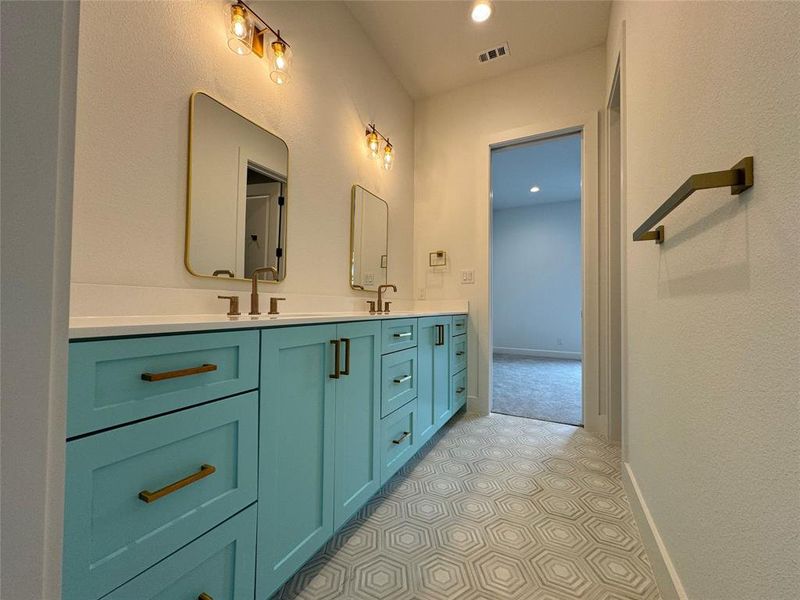 Bathroom with tile patterned flooring and dual bowl vanity