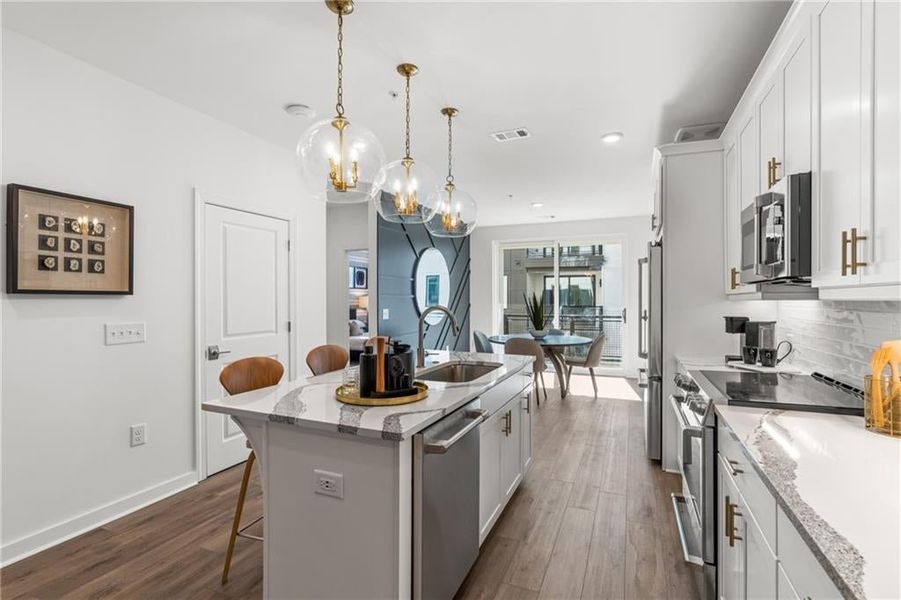 Kitchen Island with 3 pendant lights above.
*Model Home-Representative purposes only*