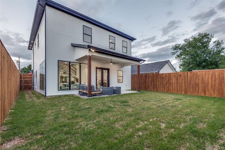 Rear view of house and patio with grassy area