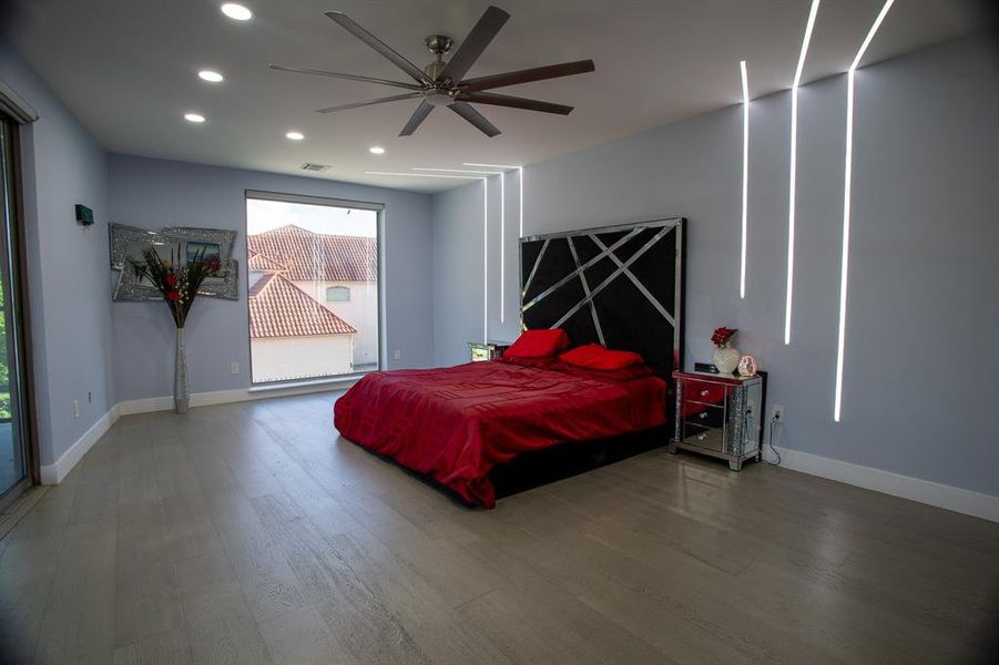 Bedroom featuring ceiling fan, dark hardwood / wood-style floors, and access to outside