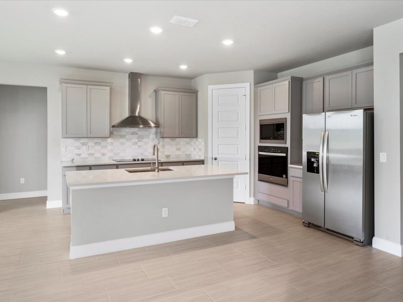 Kitchen in the Coral floorplan at 6326 NW Sweetwood Drive in Brystol at Wylder