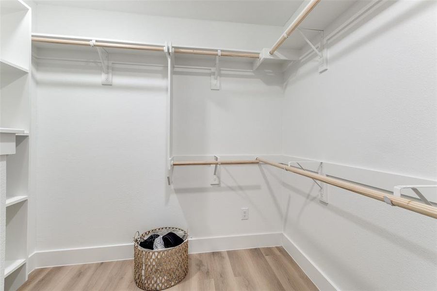 Walk in closet featuring light hardwood / wood-style floors