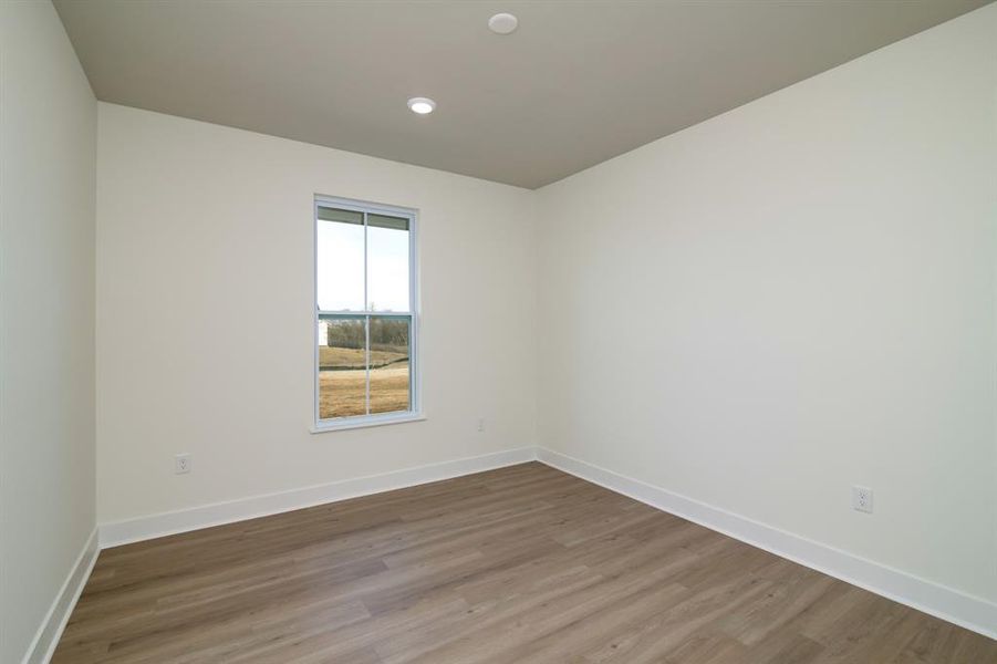 Unfurnished room featuring hardwood / wood-style floors