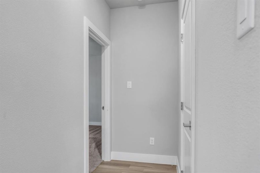 Hallway featuring light wood-type flooring