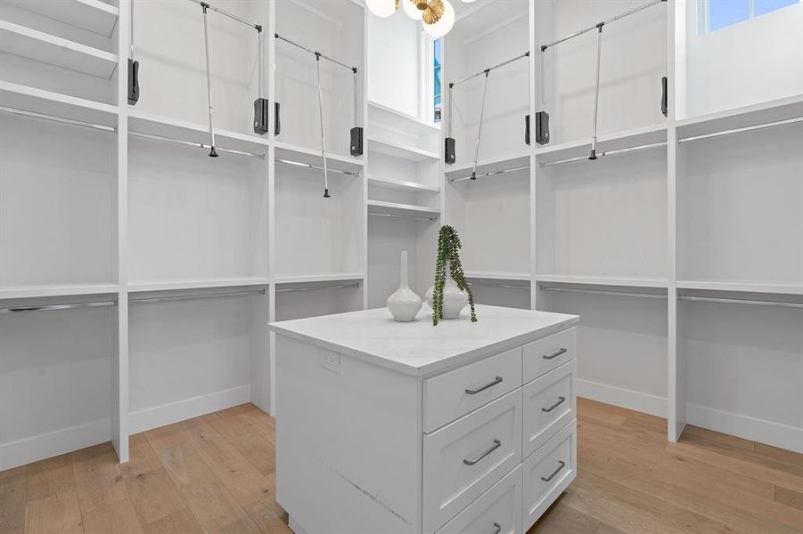 Super closet with 12 foot ceilings and seasonal pull down rods, plus packing island with drawers