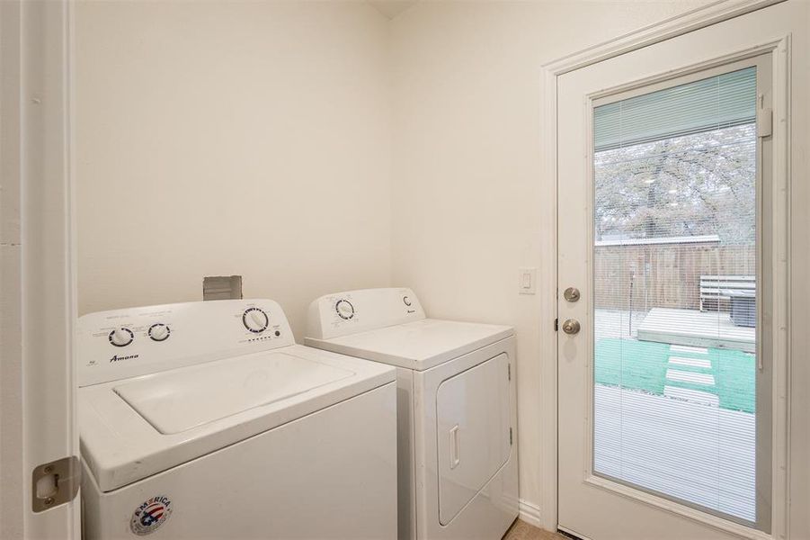 Washroom with washer and clothes dryer and a wealth of natural light