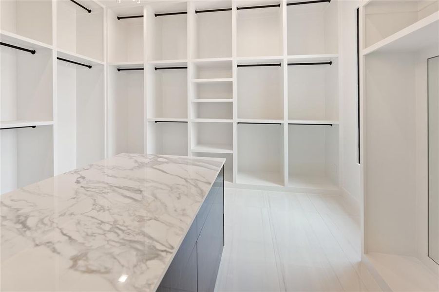 Walk in closet with built-in storage and counter space