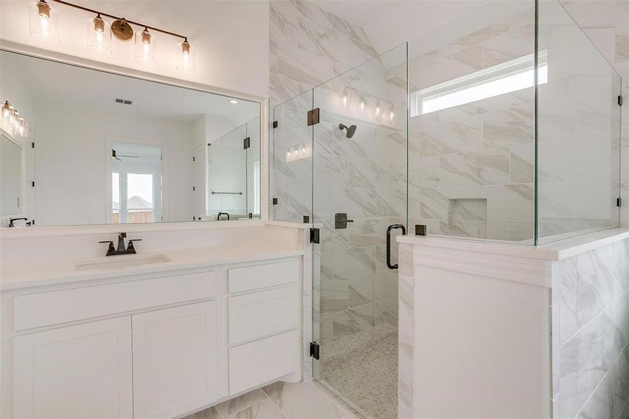 Bathroom featuring vanity and walk in shower