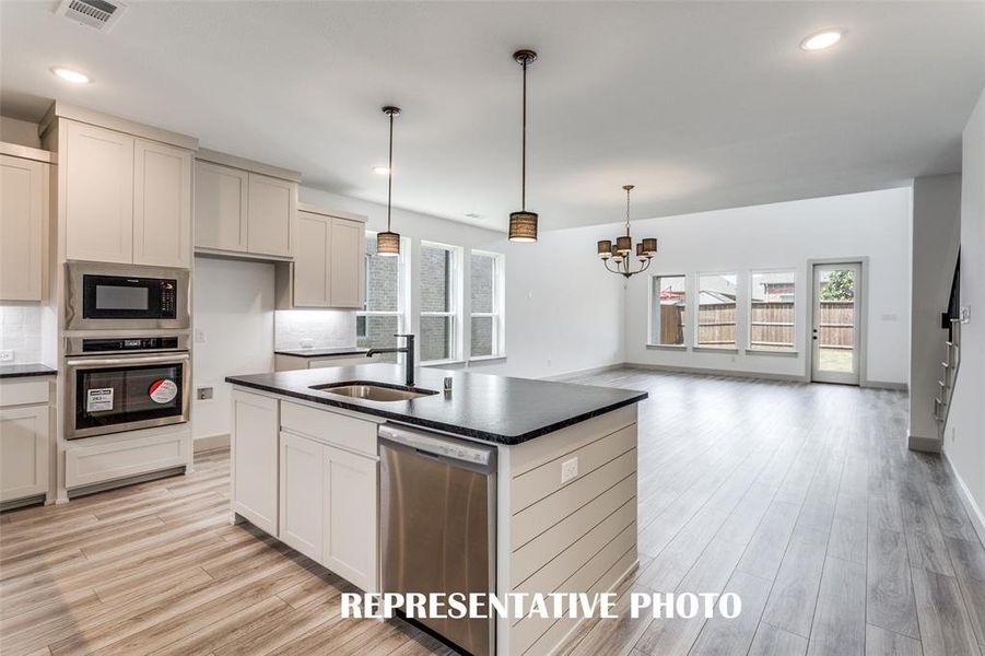 Featuring the perfect open concept design, entertaining is a breeze in our Toulouse floor plan.  REPRESENTATIVE PHOTO