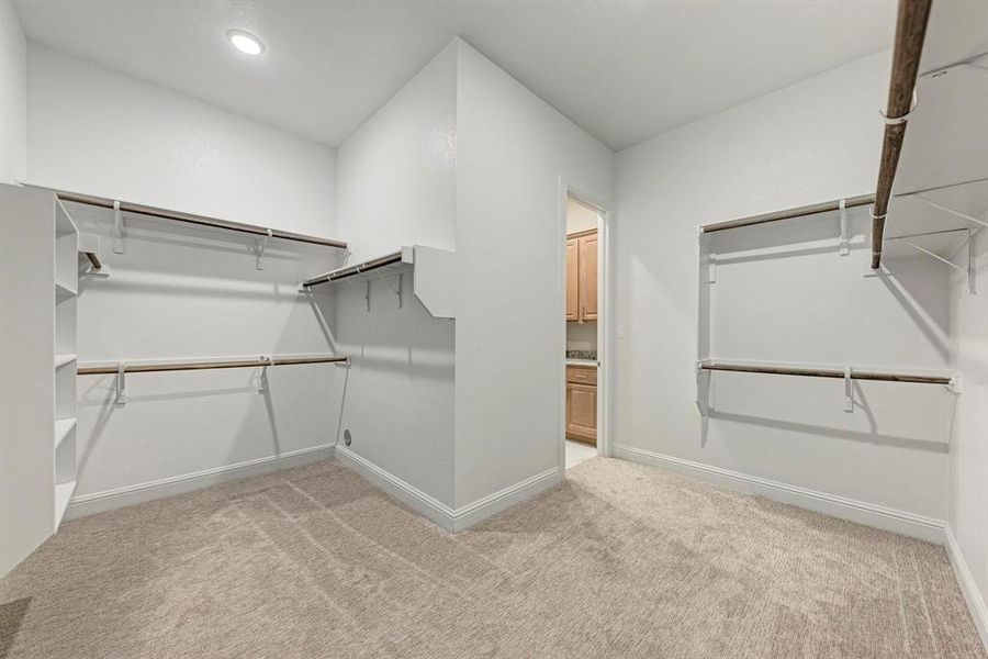 Primary Walk-In Closet leading to the Laundry Room