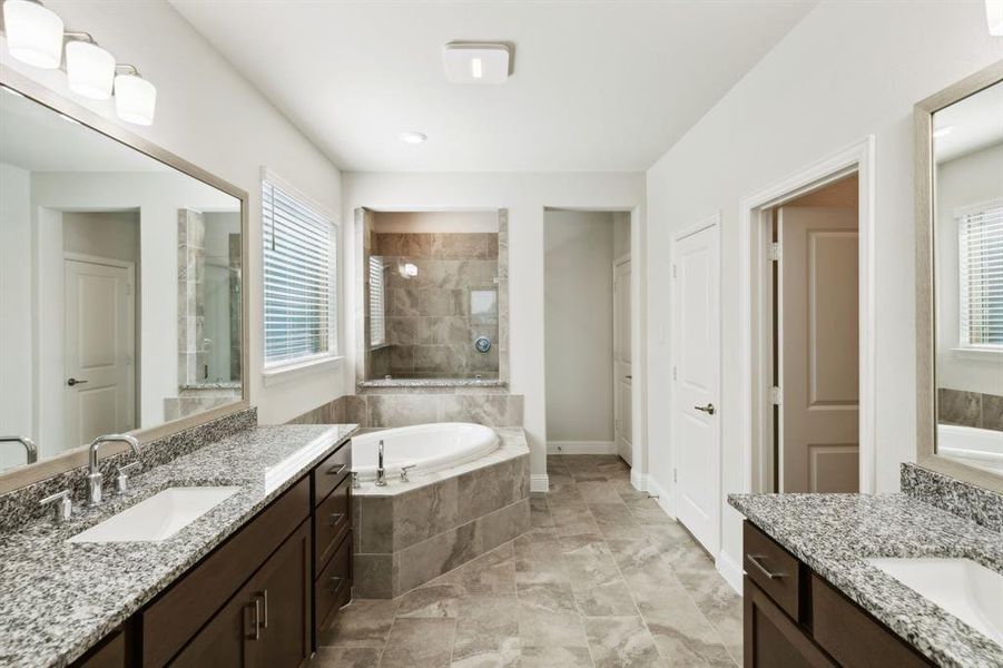 Bathroom featuring tile floors, plenty of natural light, and vanity