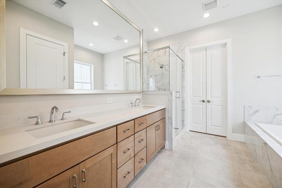 Primary bathroom retreat on the 3rd level offers a tranquil setting with a separate tub/shower.