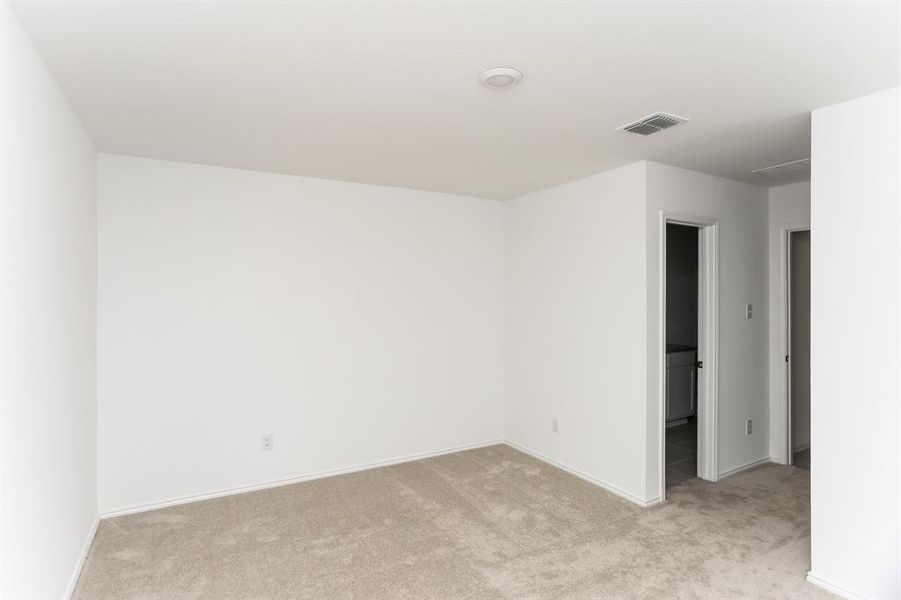 View of carpeted primary bedroom