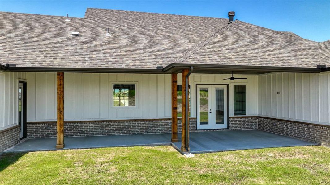 Back of house with a patio, a yard, ceiling fan, and french doors