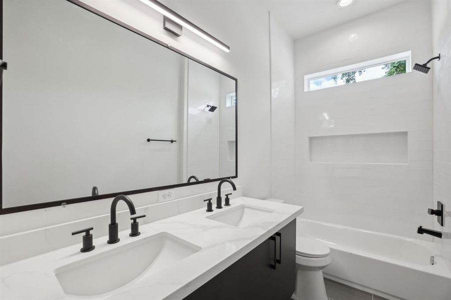 Secondary bathroom with dual vanities located on second floor