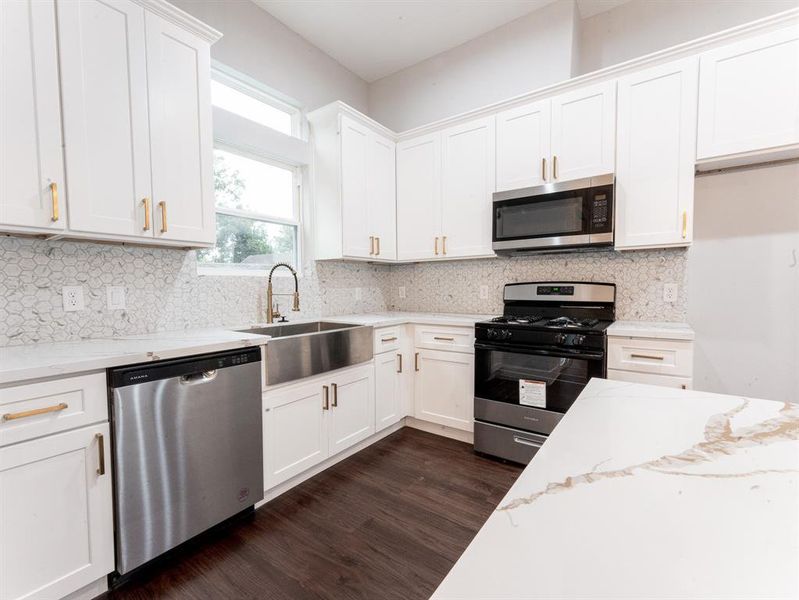 Gas Stove, Gold Hardware throughout the house