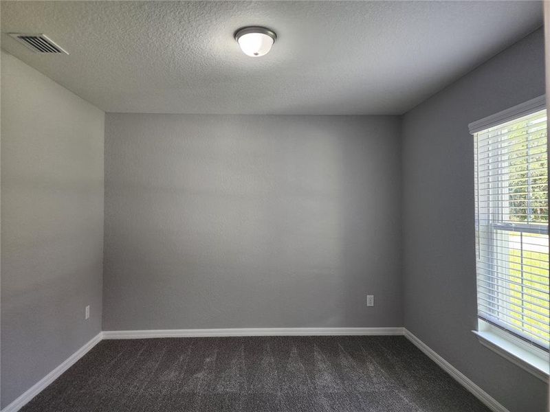 Guest Bedroom 4 (no closet) located in the front off of the foyer and is separated by a pocket door