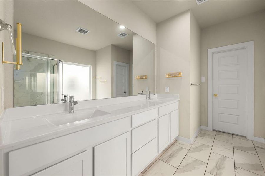 This primary bathroom is definitely move-in ready! Featuring a walk-in shower with tile surround, separate garden tub for soaking after a long day, bright cabinets with light countertops, spacious walk-in closet with shelving, high ceilings, neutral paint, sleek and modern finishes.