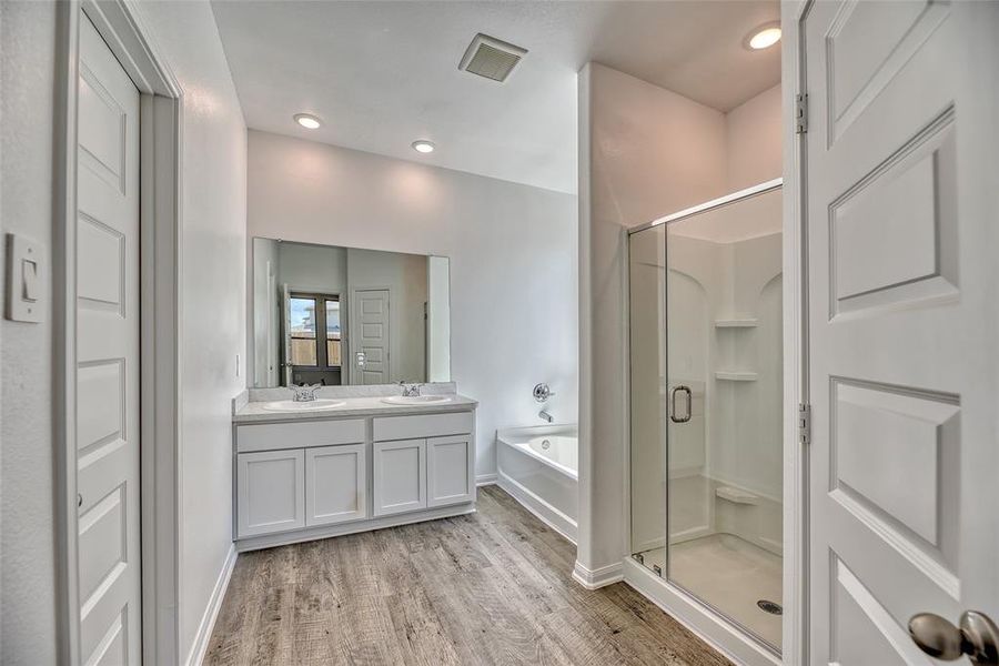 The spa-like ensuite bathroom is a haven within the retreat. From dual sinks complemented by sleek fixtures to a well-appointed layout, every detail contributes to a sense of indulgence and tranquility.