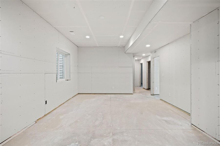 Additional framing down the hall includes a full bathroom (tub already installed), two additional bedrooms with egress and a mechanical room.