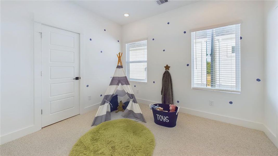 Secondary bedroom - located on the second floor. Vinyl windows with retractable panels allow in tons of natural light.