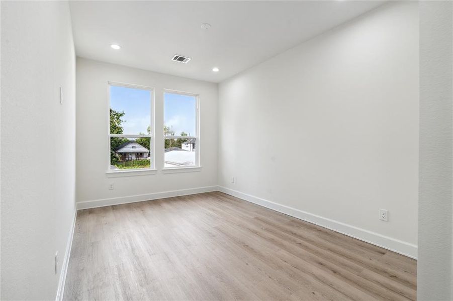 Enjoy an abundance of light even in the third guest bedroom, continuing the theme of  oversized windows found throughout the home.