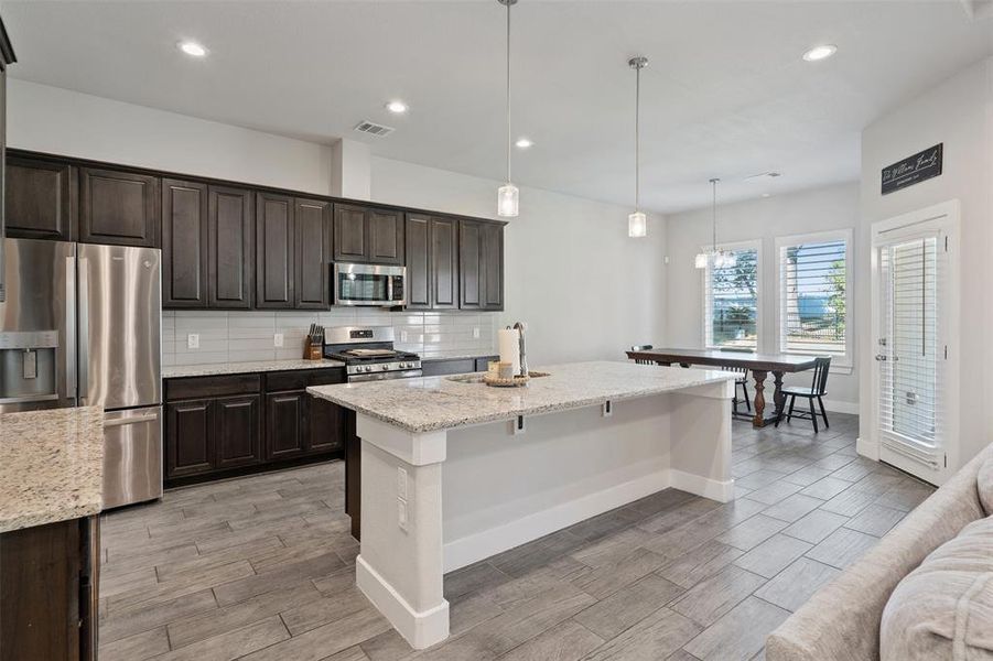 Open kitchen and dining. Over looking into living room.