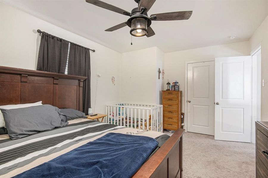 Carpeted bedroom with ceiling fan