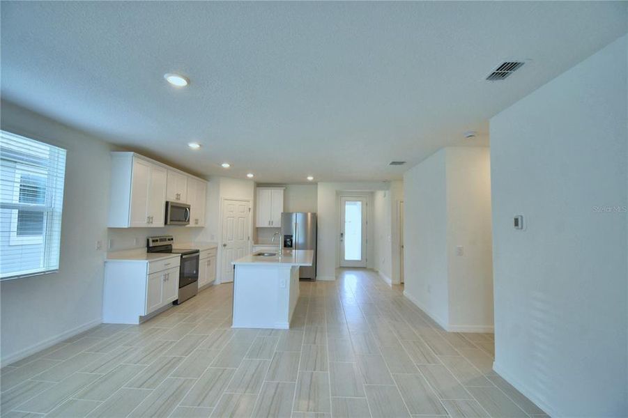 looking into kitchen, dining area from great room