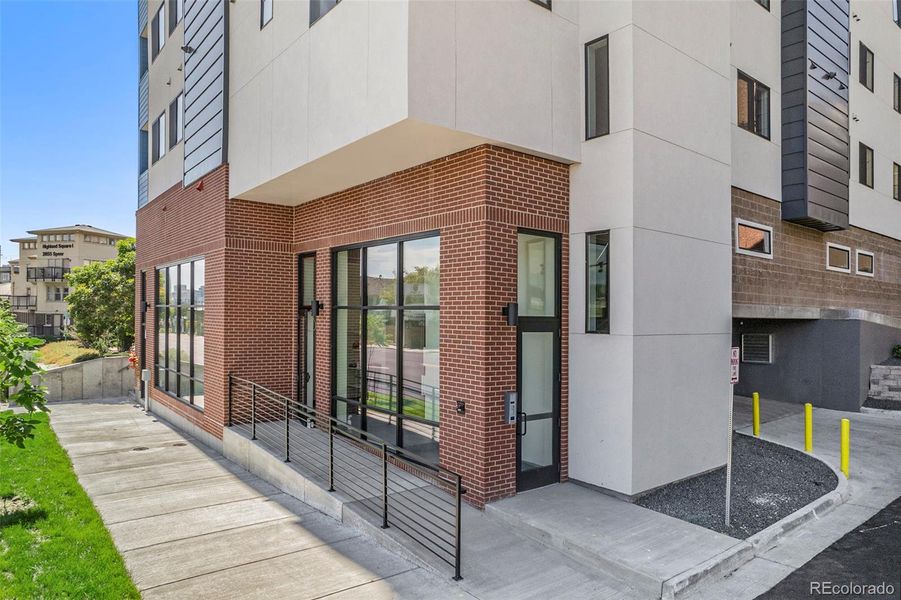 Speer28 front entrance, floor to ceiling windows brighten owners entry to common area mail box and fitness area.