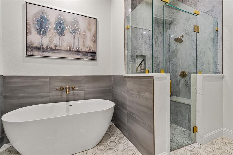 Bathroom featuring tile walls, independent shower and bath, and tile patterned flooring