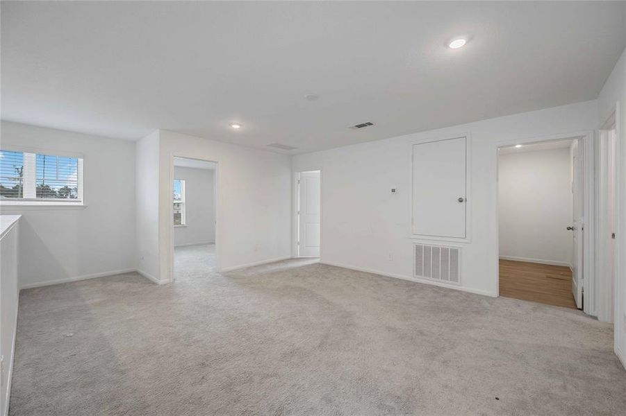 Oversized game room with adjacent laundry room.