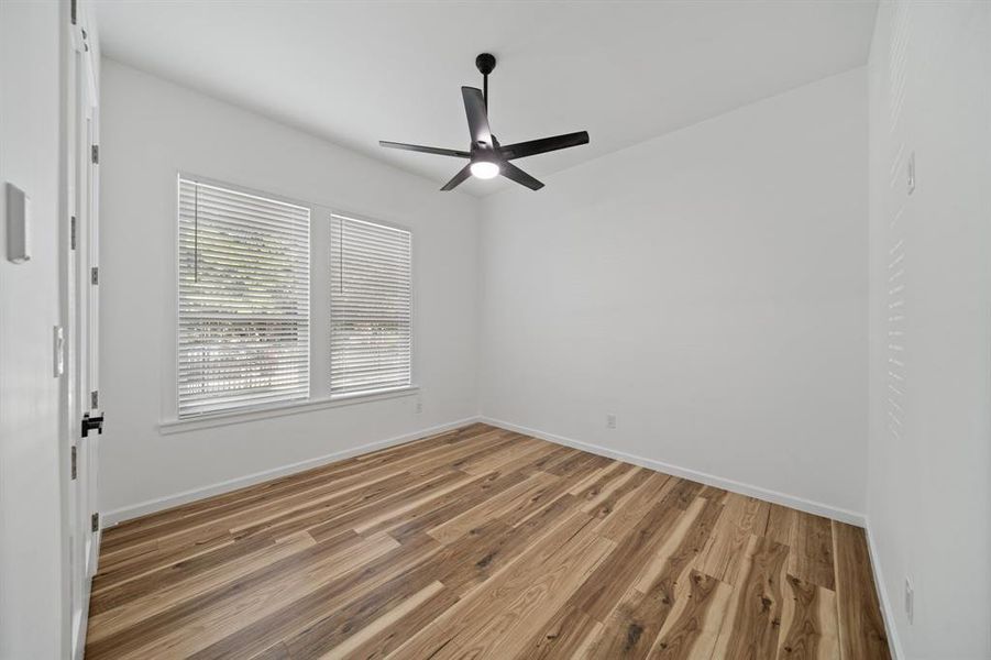 Spare room featuring wood-type flooring and ceiling fan