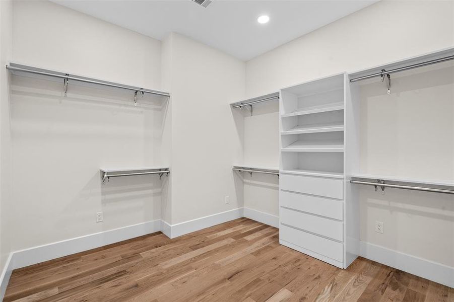 Spacious closet featuring light hardwood / wood-style flooring